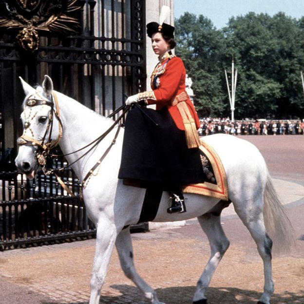 Riding side-saddle the Queen returns to Buckingham Palace