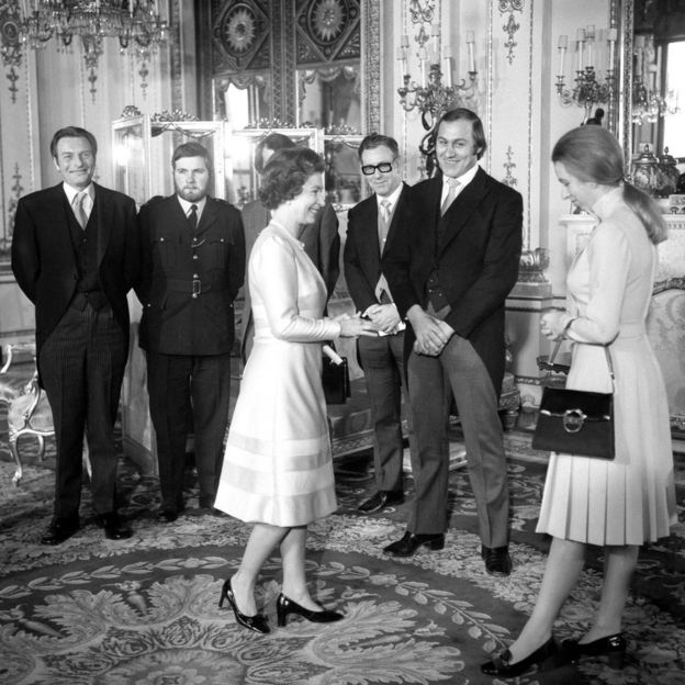 The Queen and Princess Anne in Buckingham Palace meet those decorated for their bravery in helping her avoid a kidnap attempt