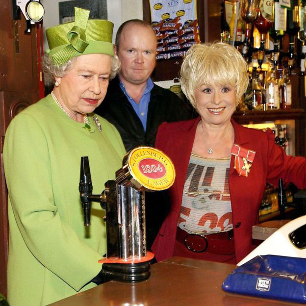 Queen Elizabeth II in the Queen Vic pub during a visit to Elstree Studios where EastEnders is filmed